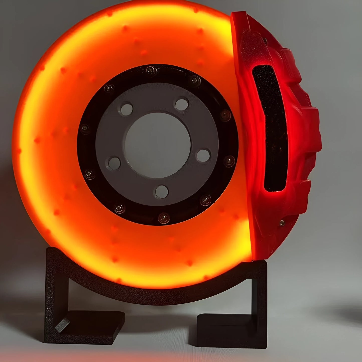 Brake disc design LED night light with caliper details in blue, red, or yellow colour options on desktop