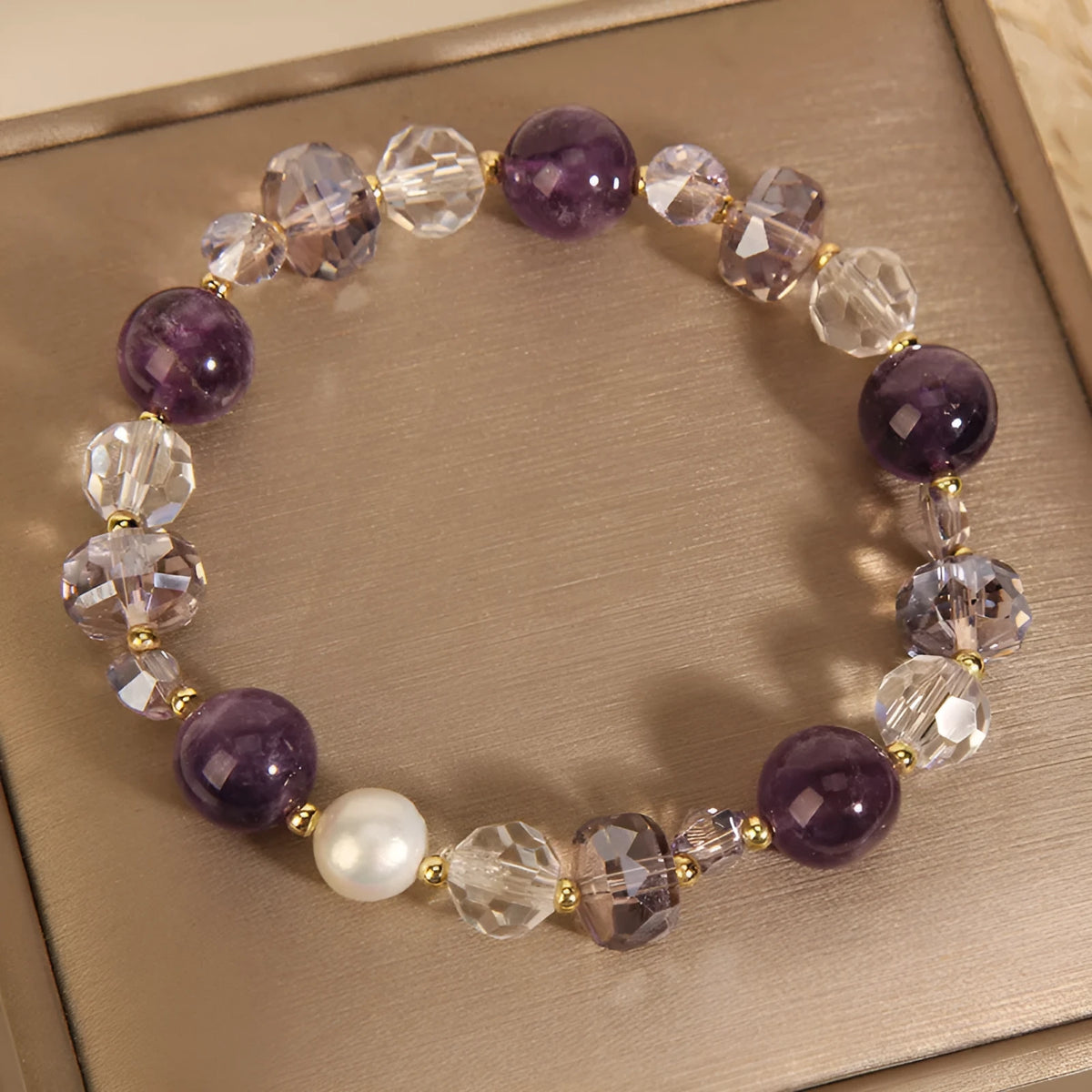 Women's artificial amethyst bracelet with U-shape design showing square stones, round stones, pearl and four-leaf clover charms
