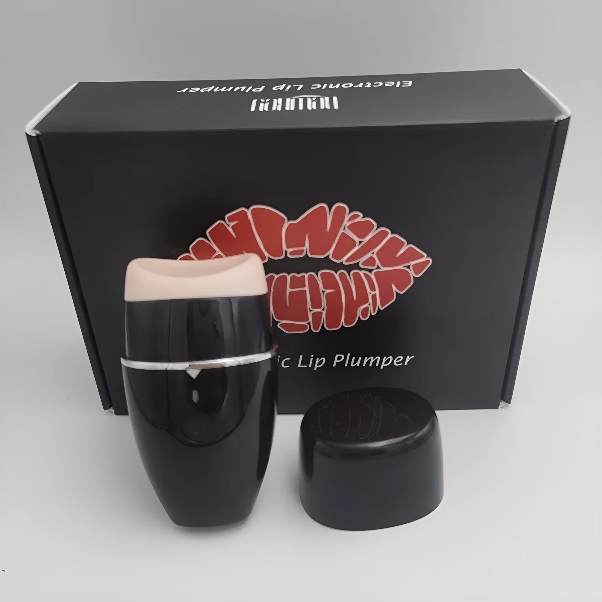 Black and white electric silicone lip plumper with 3-speed adjustment and USB charging cable