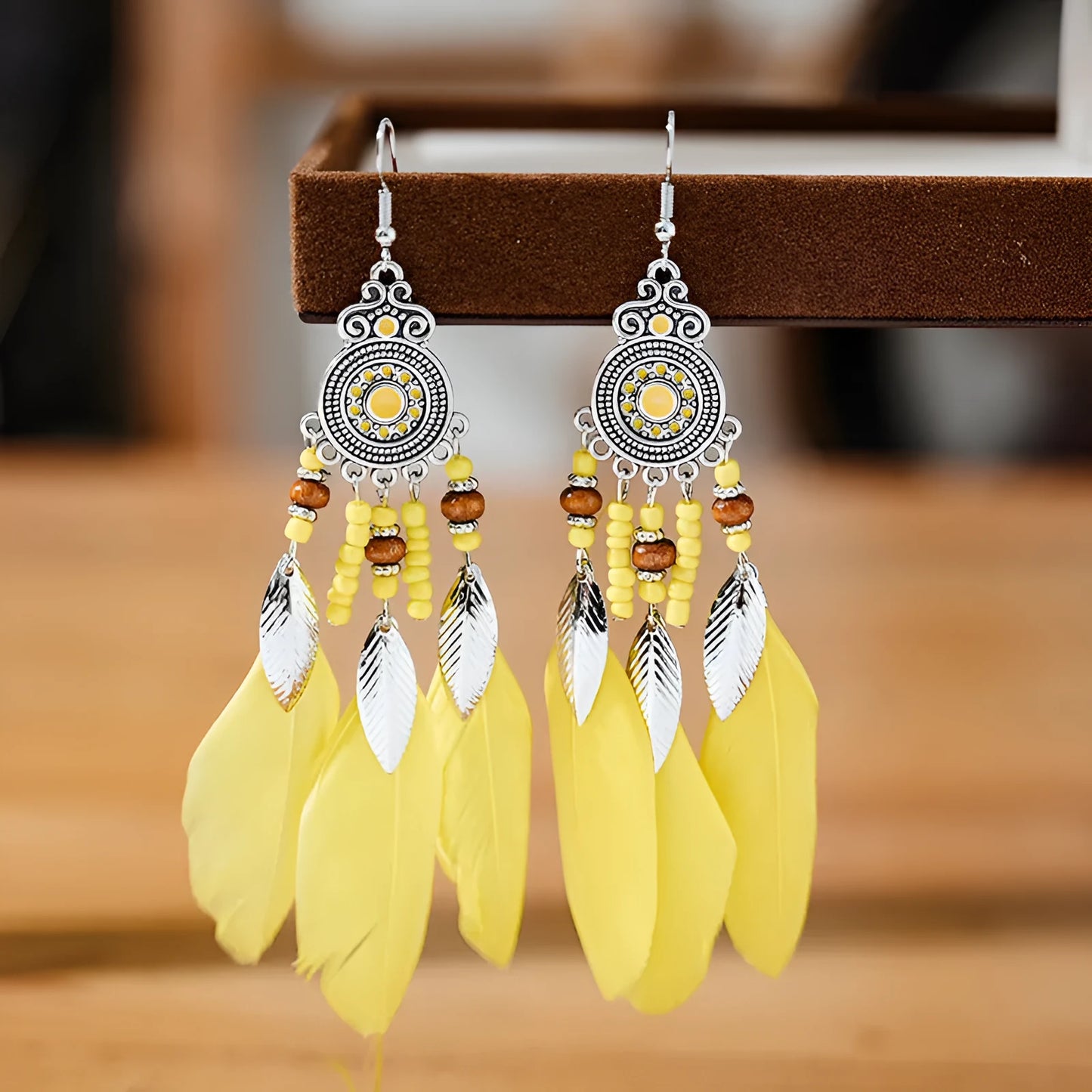 Round drop feather earrings in a bohemian leaf shape with patterned detail, shown in a light pink electroplated colour.
