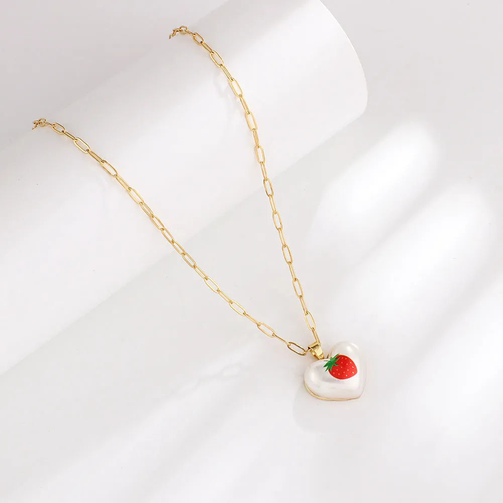 Geometric fruit heart pendant necklace on an adjustable chain, showing strawberry, pineapple, apple, pear, and cherry design options.