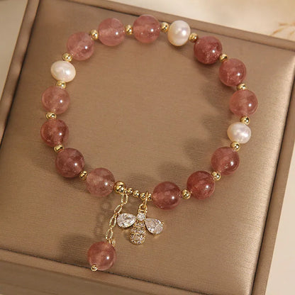 Women's adjustable bracelet with freshwater pearls, strawberry quartz stones, and bee charm