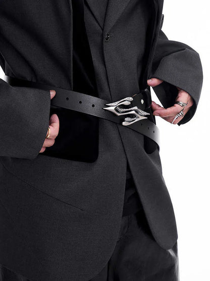 Men's black leather belt with a silver metal letter-design buckle on a flat surface.