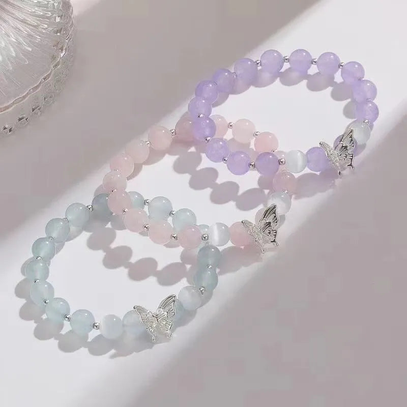 Women's crystal bow bracelet with butterfly design in ocean blue, pink, and purple colour options