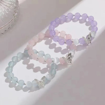 Women's crystal bow bracelet with butterfly design in ocean blue, pink, and purple colour options