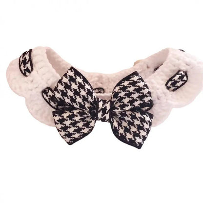 Red and black houndstooth patterned wool knitted collar for pets on a white background.