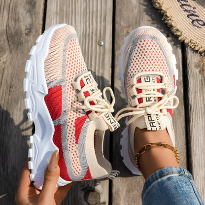 Women's Flyknit mesh lace-up sneaker in a grey colourway showing round toe and rubber sole.