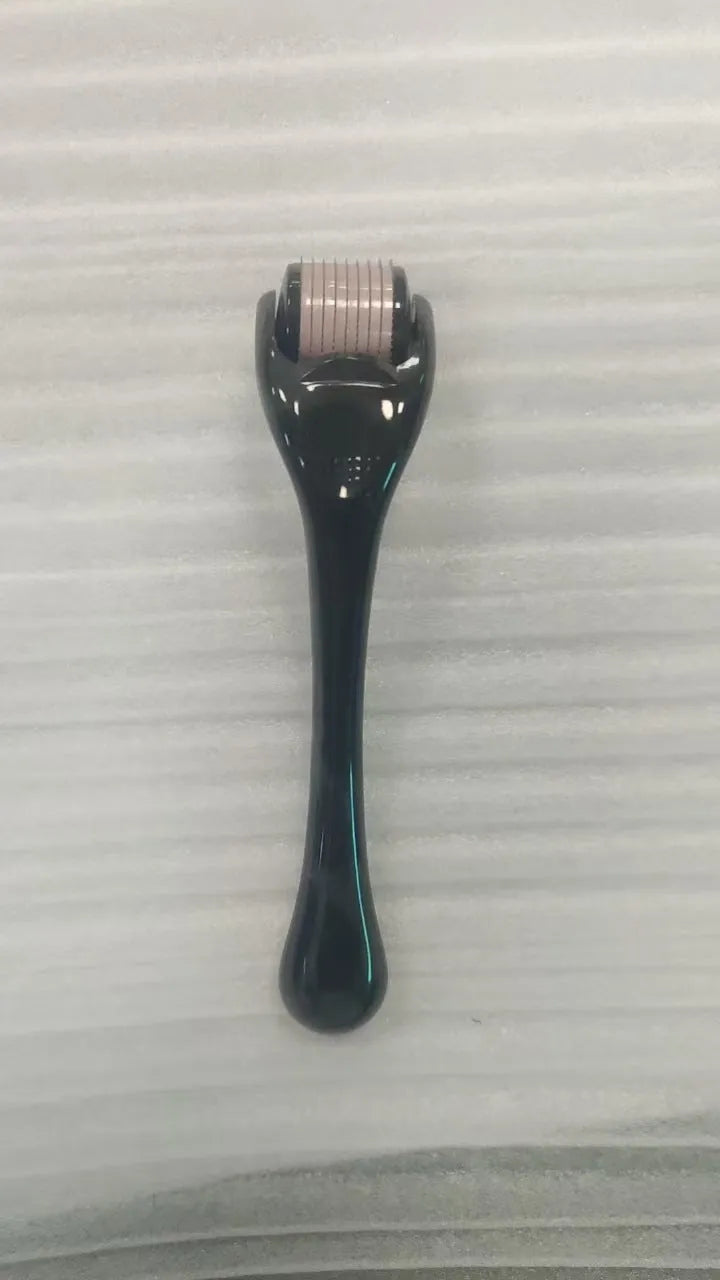Sterile micro needle derma roller with black handle and coloured wheel on white background