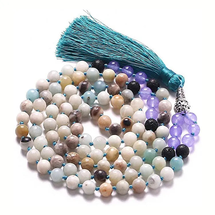 Long multi-coloured agate and stone tassel necklace with geometric beads on a white background.