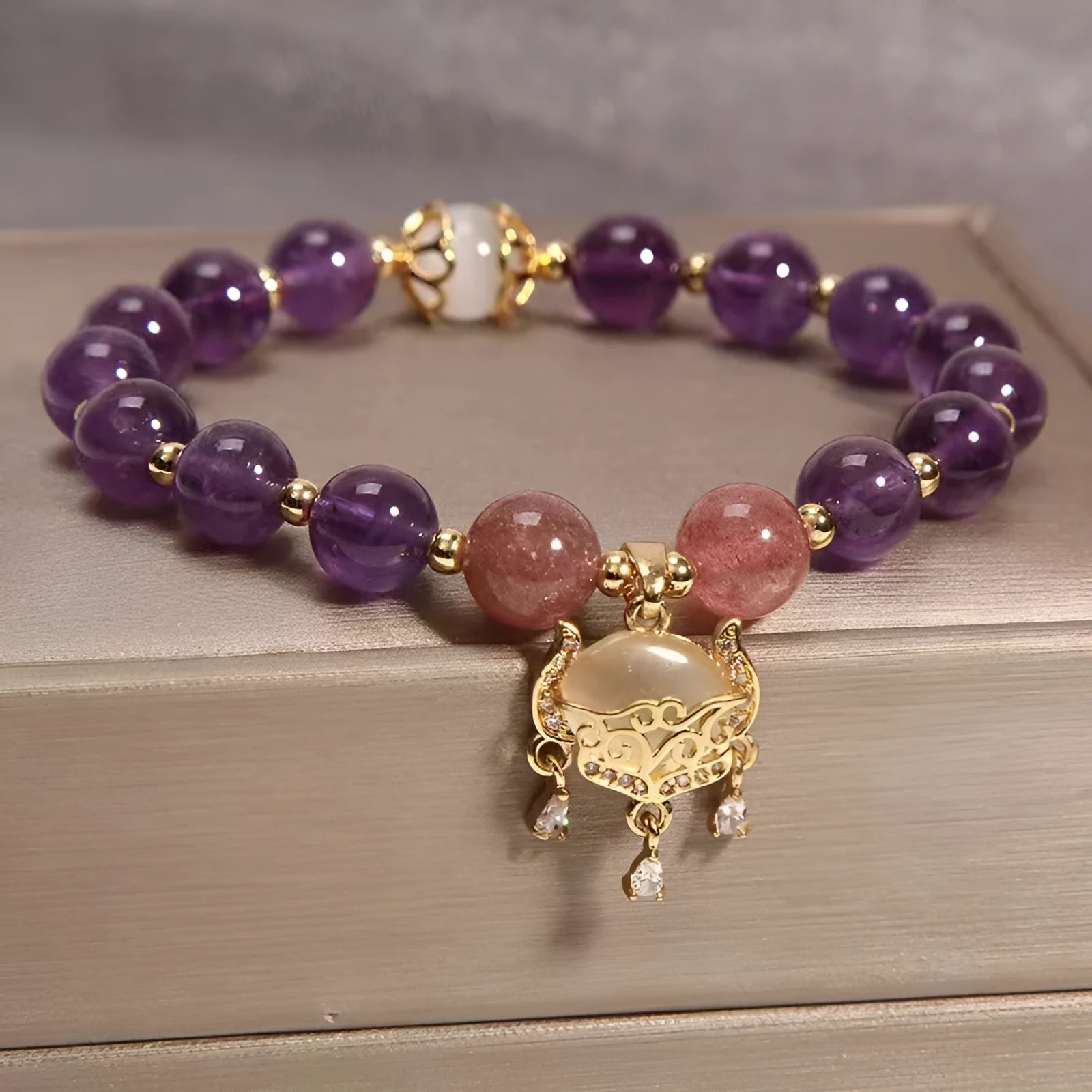 Copper longevity lock bracelet for women with drop-shaped charm, Ruyi and safety lock symbols.