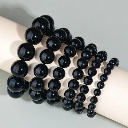 Hand-woven obsidian crystal bracelet showing round beads with ethnic styling in multiple colour options