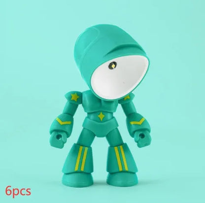 Mini mecha robot hero LED night light with adjustable arms on a desk.