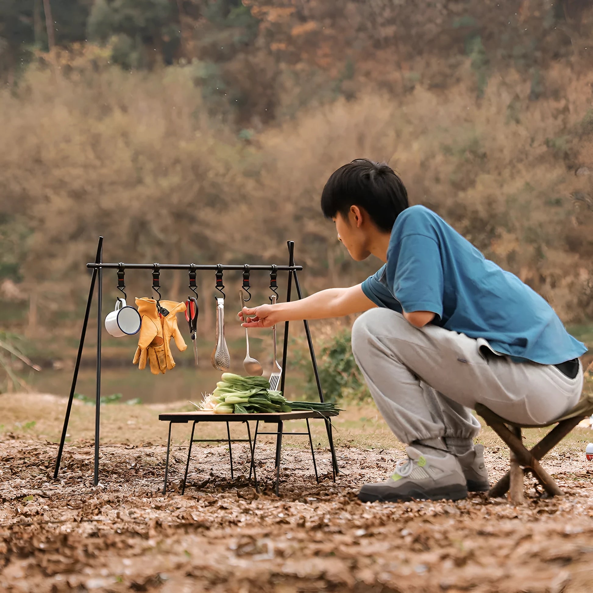 Aluminium alloy folding clothes drying rack with triangle frame and side hanger hooks for camping.