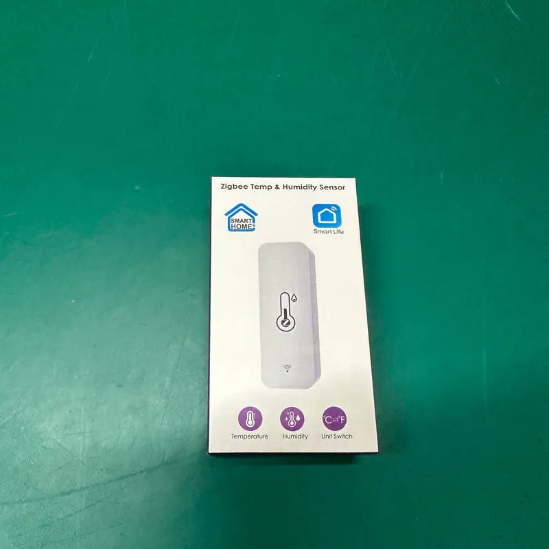 Compact white ABS plastic WiFi and Zigbee temperature and humidity sensor for smart homes.