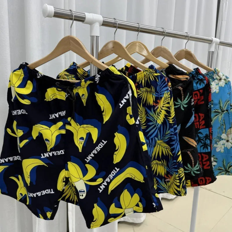 Men's summer beach pants in loose casual style with quick-drying ice silk fabric, high elasticity and free size fitting 55kg to 95kg, featuring floral and stripe printed patterns for casual beach wear