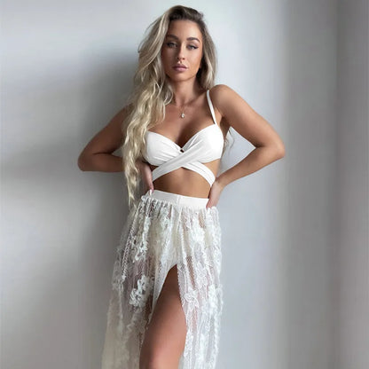 White three-piece backless push-up bikini set with matching skirt on a mannequin.