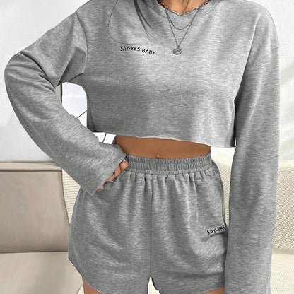 Grey women's long-sleeved T-shirt and shorts polyester lounge set laid flat.