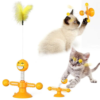 Cat playing with rotating windmill toy featuring luminous balls and suction base