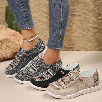 Women's black slip-on flat shoes with round toe and low-top design on a neutral background.