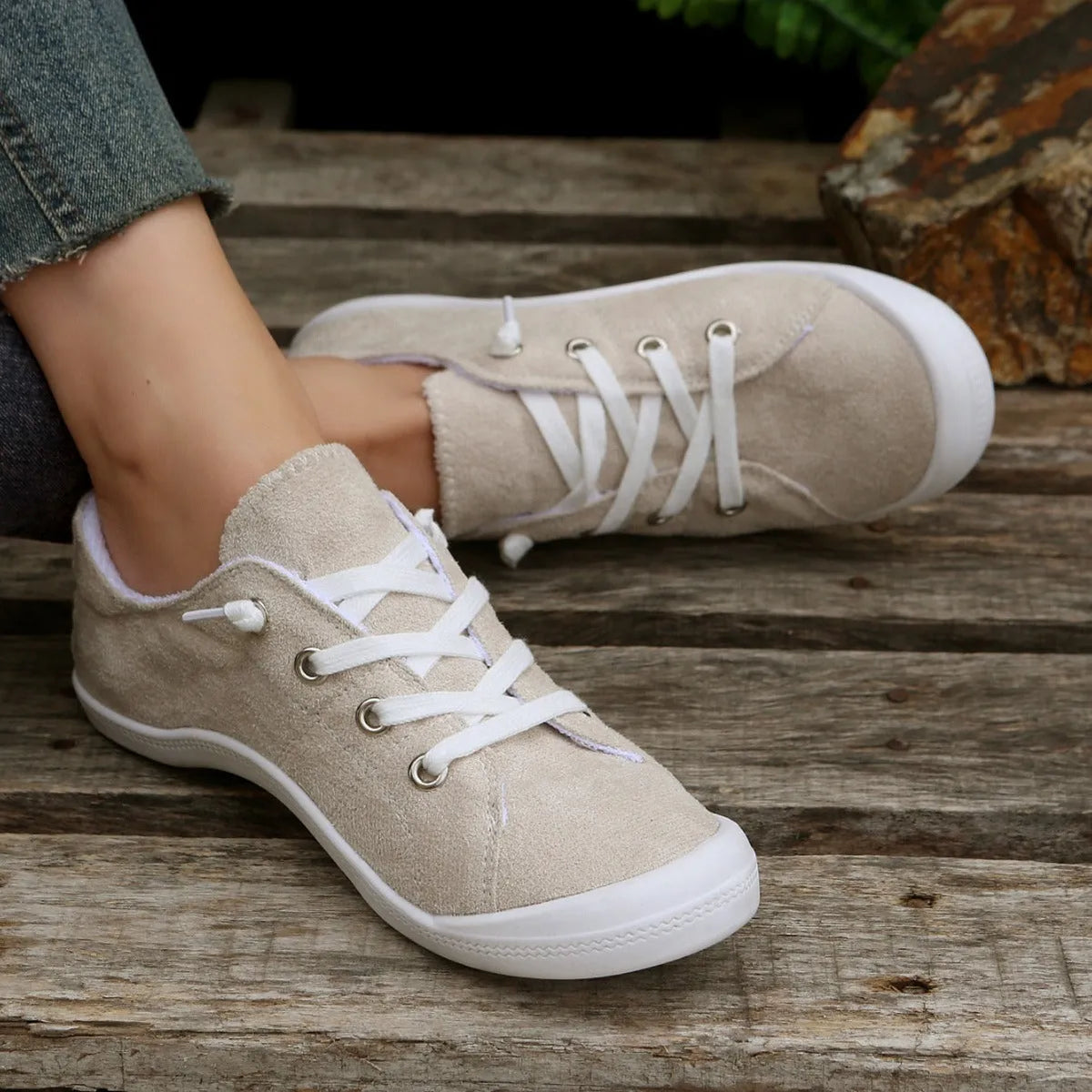 Women's creamy white low-top casual sneaker with fabric upper and rubber sole.