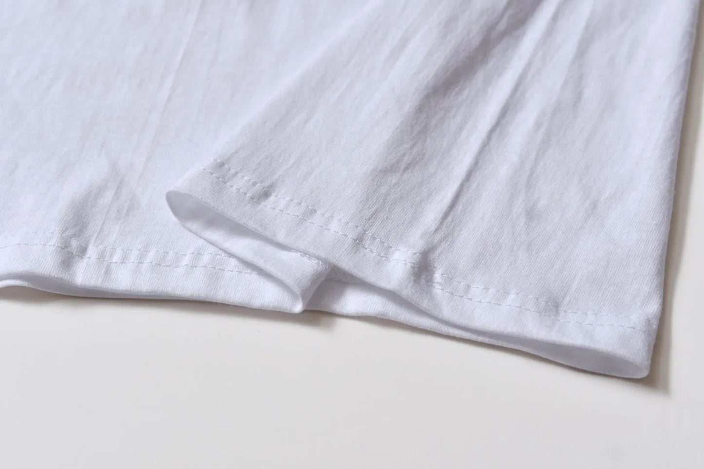 White cotton T-shirt style overalls with short sleeves and loose fit pullover design