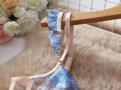 Light blue embroidered lace push-up bra and matching underwear set with mesh panels on a mannequin.