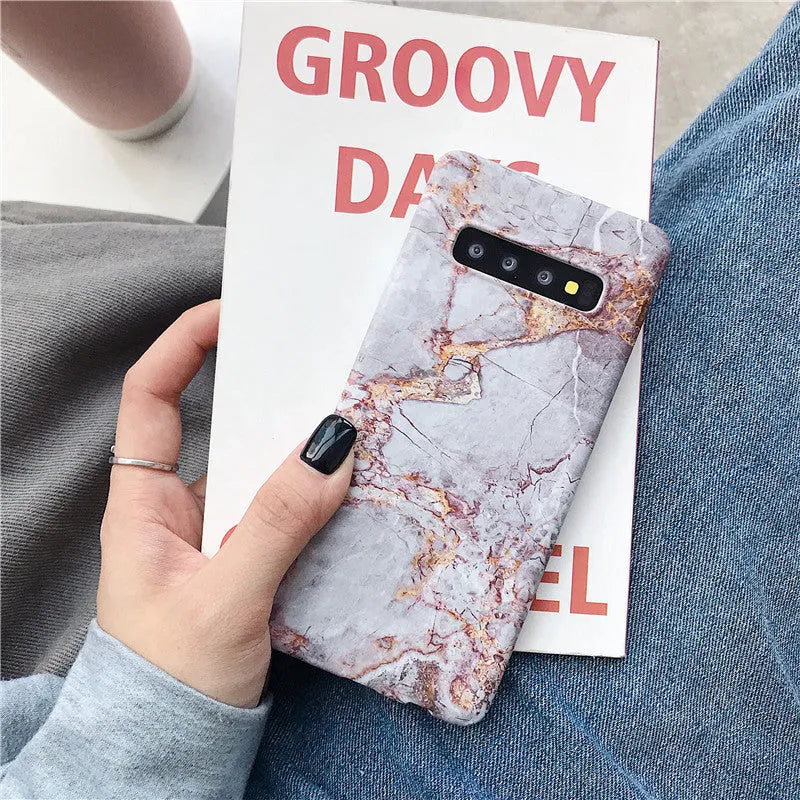 Samsung phone case with white and grey marble pattern on a polycarbonate back cover.
