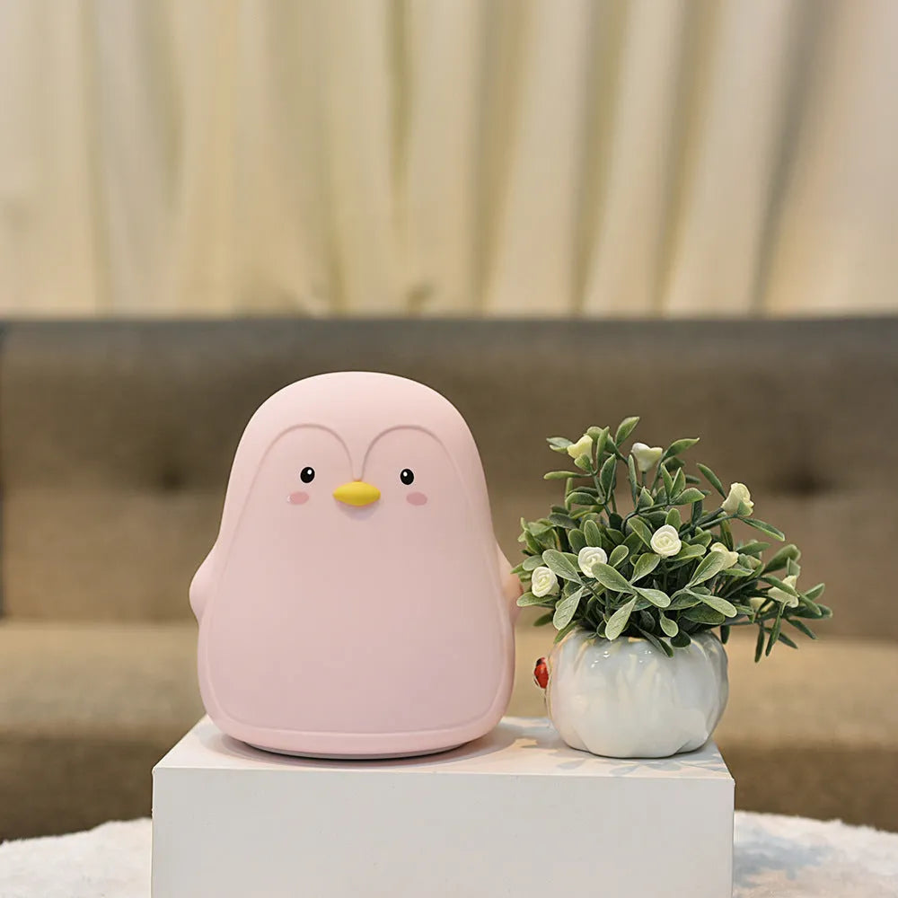 Penguin-shaped USB rechargeable night light with soft white glow