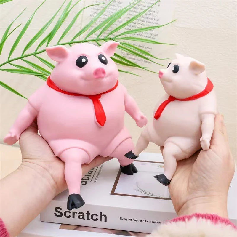 Adorable piggy-shaped stress relief toy made of eco-friendly rubber with a charming red scarf design