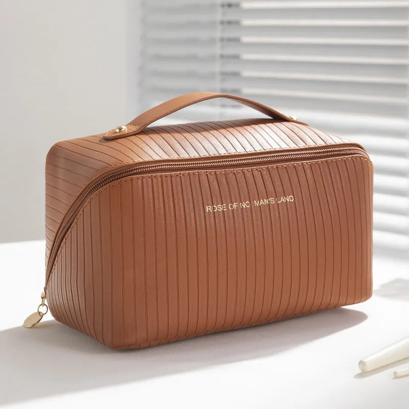 Beige cubic makeup bag with vertical pattern measuring 22.5 by 12.5 by 12.5 centimetres
