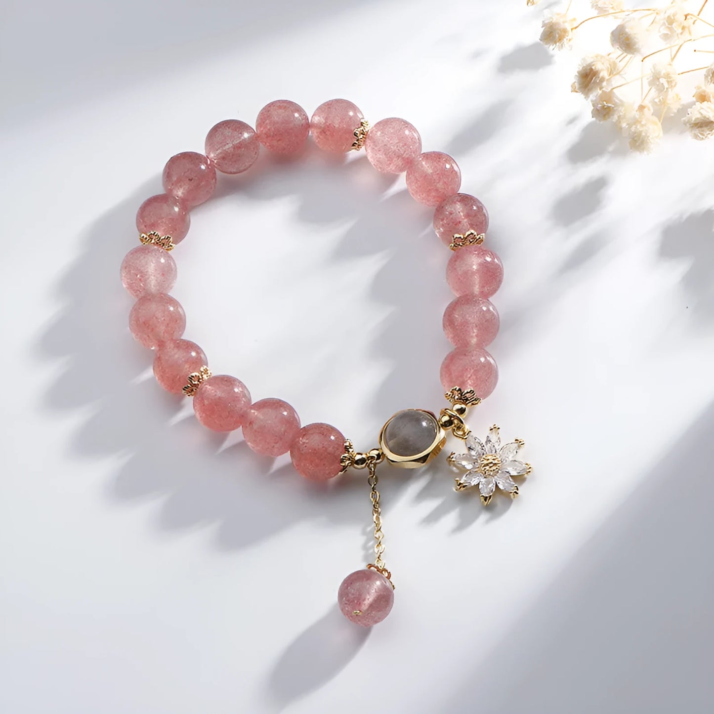 Korean Mori style crystal bracelet with a strawberry quartz bead and floral electroplated metal details