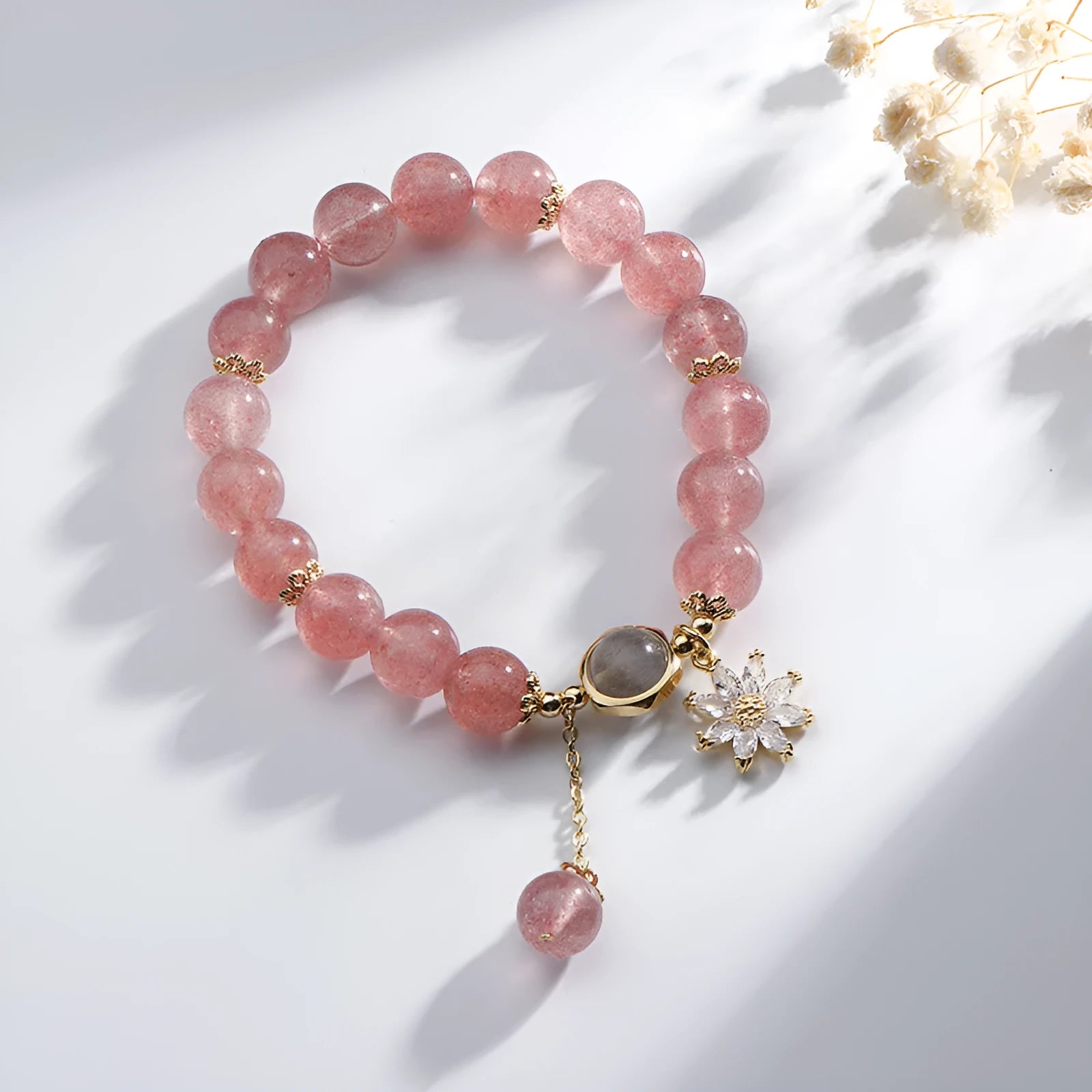 Korean Mori style crystal bracelet with a strawberry quartz bead and floral electroplated metal details
