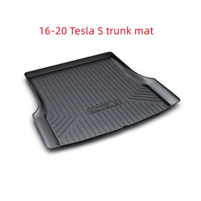 Custom black rubber floor mats with textured surface and TPE driver's footrest, fitted in a Tesla interior.