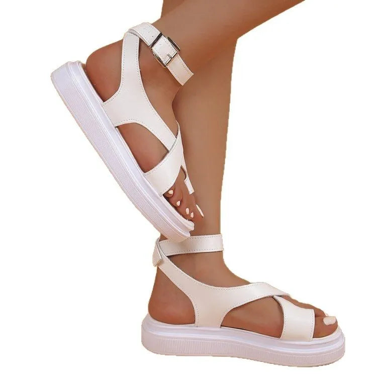 Women's white and black Roman-style lace buckle sandals with thick composite sole on a neutral background.