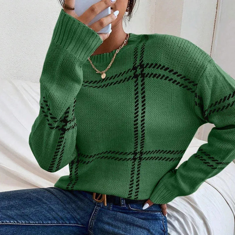 Women's loose-fitting plaid crew neck sweater with apricot, black, beige, red, and green colour-block stripes.