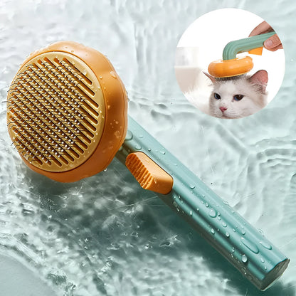 Hand-held pumpkin-coloured pet brush with stainless steel needles for grooming cats and dogs
