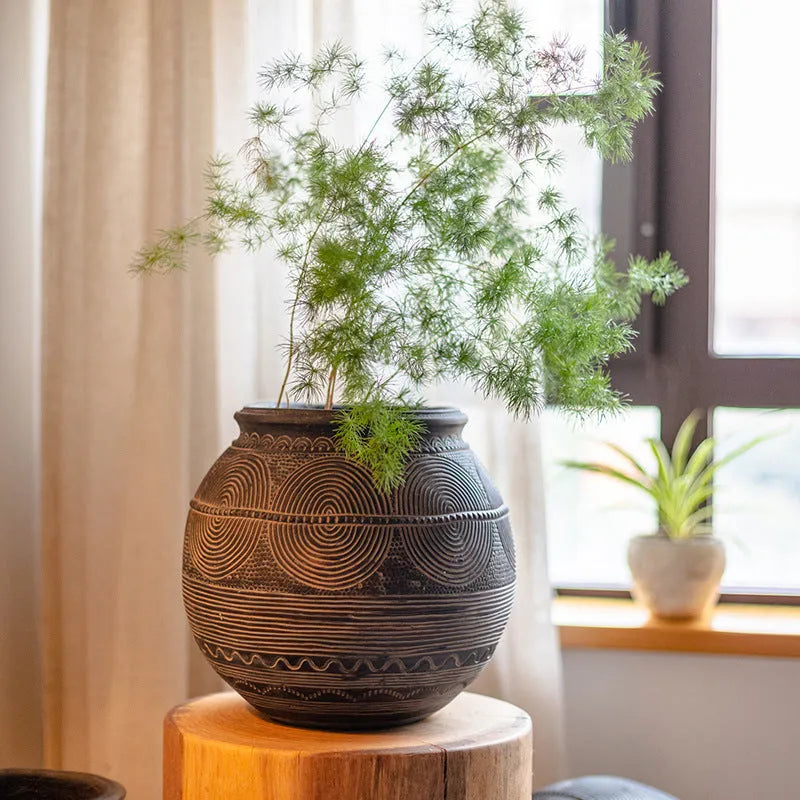 Medium cement African Ancient Tank style flower pot with a textured finish and drainage hole.