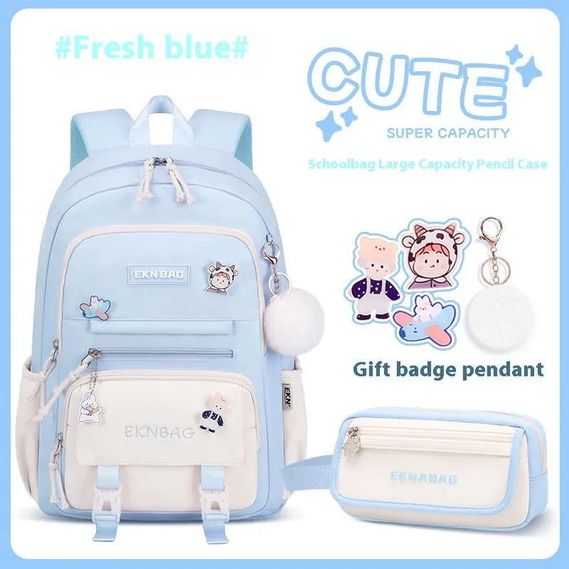Pink waterproof school backpack for girls with curved ergonomic shoulder straps, shown with matching pencil case.