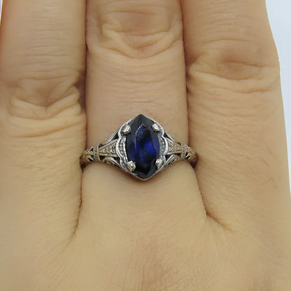Silver women's ring with geometric hollow pattern and zircon detail on a finger.