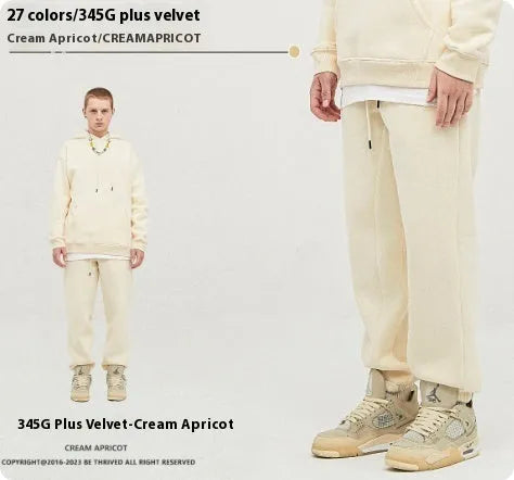Man wearing solid colour cotton velvet sweatpants with an ankle banded design in a dark grey shade.