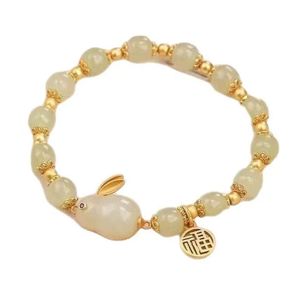 Green jade Lucky Hare charm bracelet with black cord and lily engraving.