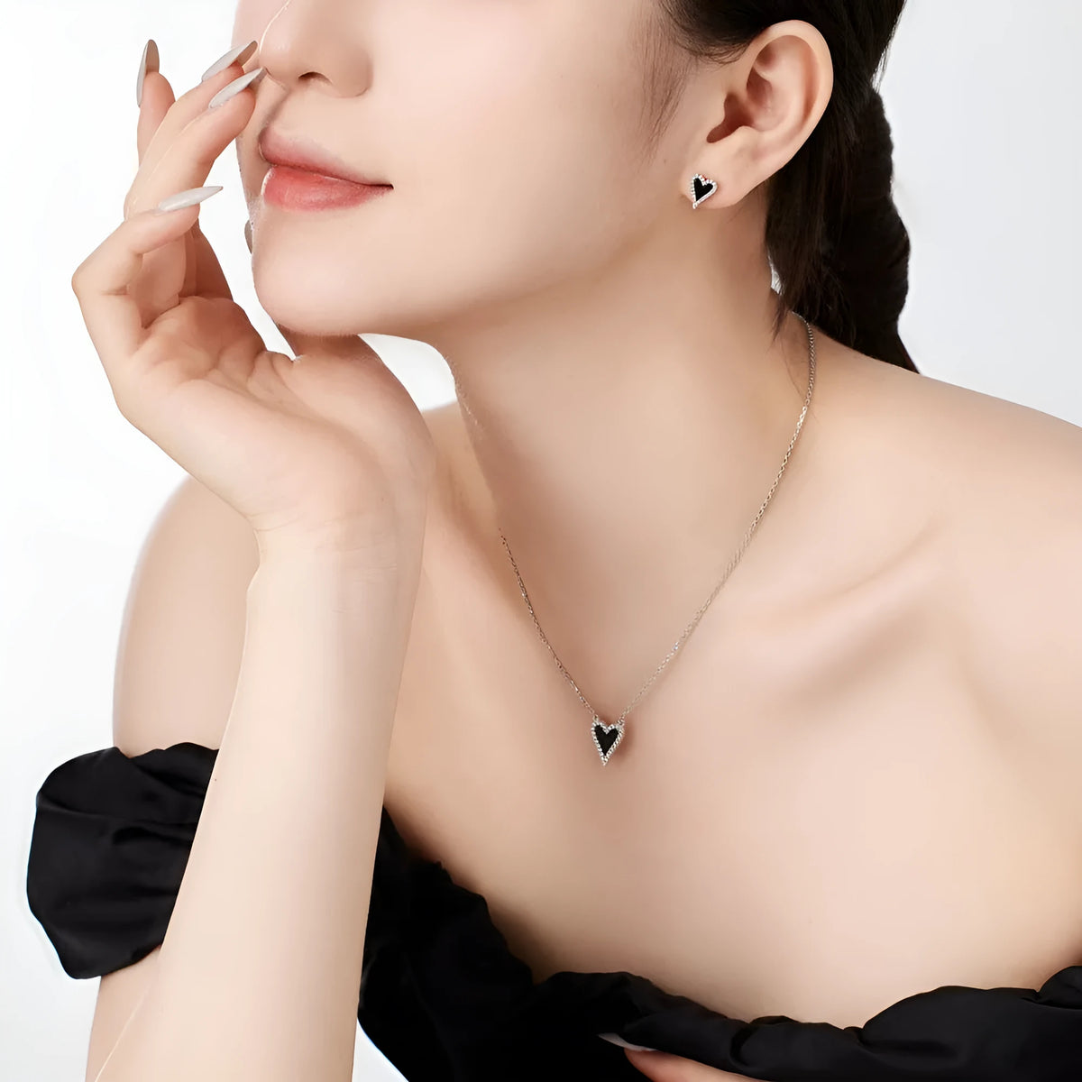 S925 silver heart-shaped stud earrings with black agate and white stone in a cold wind style, one pair