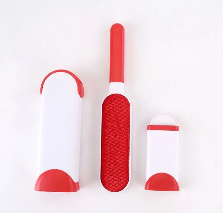 Blue reusable pet hair removal brush with double-sided head next to its self-cleaning base.