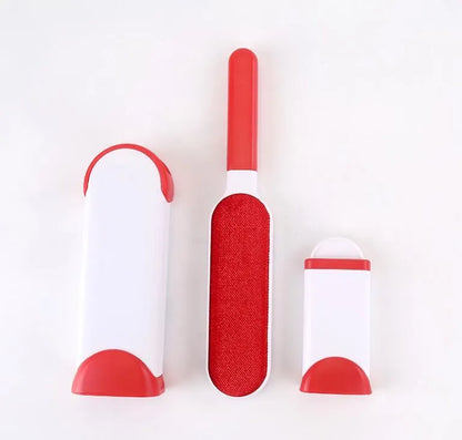 Blue reusable pet hair removal brush with double-sided head next to its self-cleaning base.