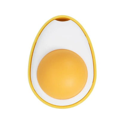 Fried egg shaped plush cat toy stuck to a window with a cat paw batting the 360-degree rotating ball.