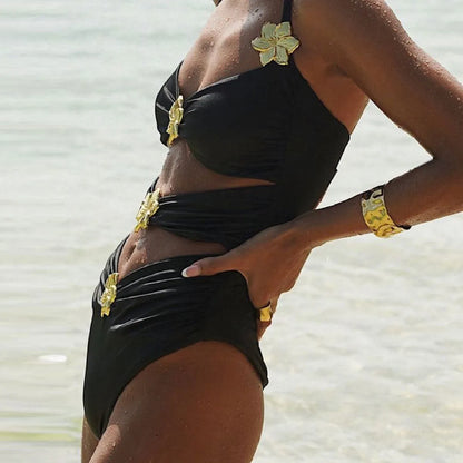 Women's solid colour one-piece swimsuit with attached short skirt in black, showing high-waisted fit and hollow-out tube top design.