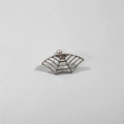 Close-up of a geometric spider web design on a gold-toned metal stud earring.