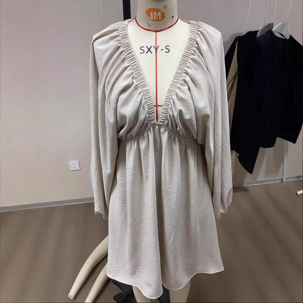 Women's apricot V-neck dress with long puff sleeves and a flounced swing skirt.