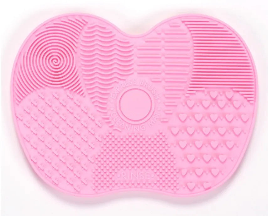 Silicone makeup brush cleaning pad, 15.5 x 12 cm, shown as a coloured brush cleaner mat for cleansing makeup brushes.