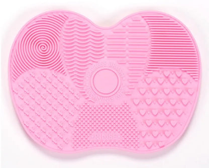 Silicone makeup brush cleaning pad, 15.5 x 12 cm, shown as a coloured brush cleaner mat for cleansing makeup brushes.